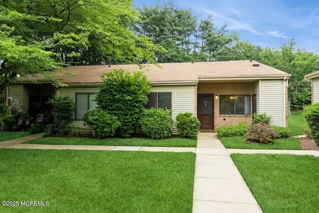 239 Medford Ct Unit B, Manalapan, NJ 07726 - view of front facade featuring a front yard and brick siding