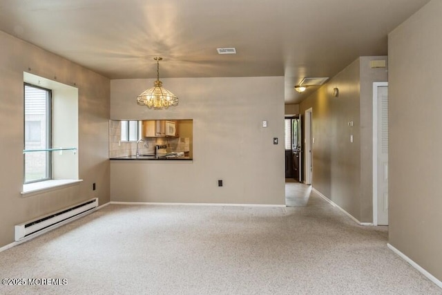 239 Medford Ct Unit B, Manalapan, NJ 07726 - empty room with a baseboard radiator, plenty of natural light, and light colored carpet