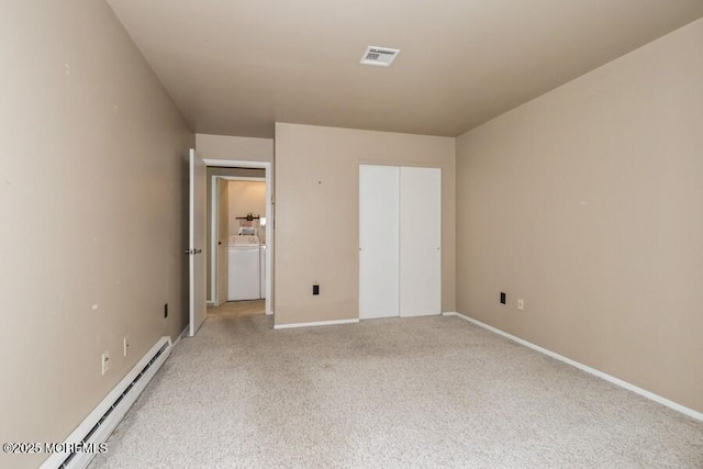 239 Medford Ct Unit B, Manalapan, NJ 07726 - unfurnished bedroom featuring baseboard heating, washer and dryer, and light colored carpet