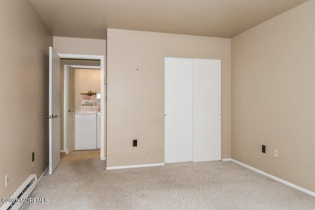 239 Medford Ct Unit B, Manalapan, NJ 07726 - unfurnished bedroom featuring a baseboard radiator, washing machine and clothes dryer, and light colored carpet