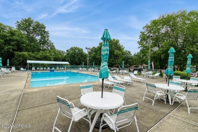 239 Medford Ct Unit B, Manalapan, NJ 07726 - community pool with a patio area and view of scattered trees