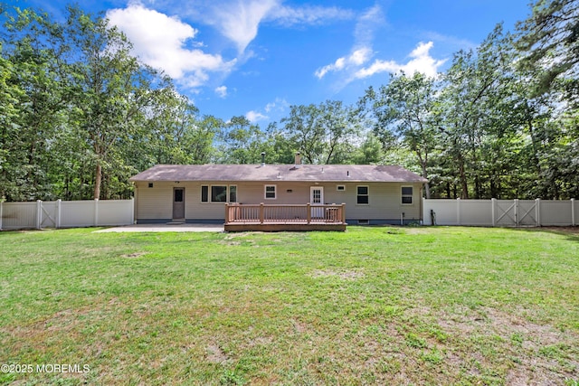 271 S Stump Tavern Rd, Jackson, NJ 08527 - back of property with a fenced backyard, a deck, and view of wooded area