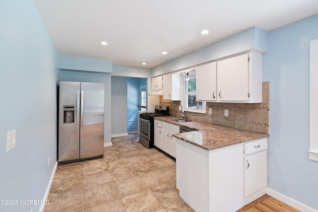 271 S Stump Tavern Rd, Jackson, NJ 08527 - kitchen featuring stainless steel appliances, tasteful backsplash, white cabinets, a peninsula, and light stone counters