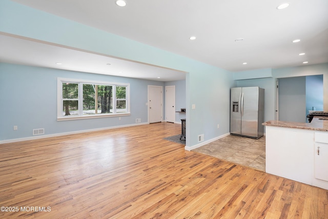 271 S Stump Tavern Rd, Jackson, NJ 08527 - kitchen featuring stainless steel refrigerator with ice dispenser, light wood-style flooring, recessed lighting, white cabinetry, and open floor plan
