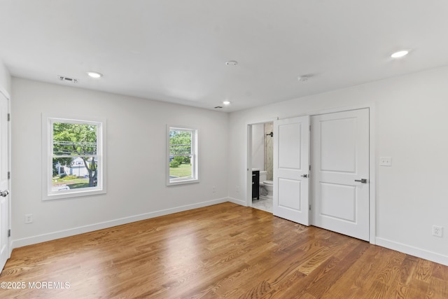 14 New Brunswick Ave, Matawan, NJ 07747 - unfurnished bedroom featuring multiple windows, light wood-style flooring, connected bathroom, and recessed lighting
