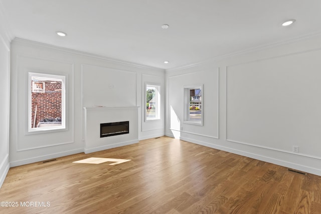 14 New Brunswick Ave, Matawan, NJ 07747 - unfurnished living room with a decorative wall, crown molding, a glass covered fireplace, and light wood finished floors