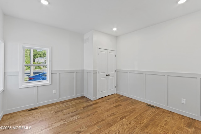 14 New Brunswick Ave, Matawan, NJ 07747 - unfurnished room featuring wood finished floors, a wainscoted wall, a decorative wall, and recessed lighting