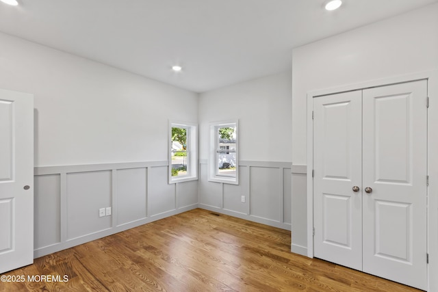 14 New Brunswick Ave, Matawan, NJ 07747 - unfurnished bedroom with a wainscoted wall, wood finished floors, recessed lighting, and a decorative wall