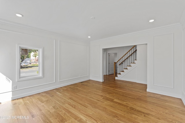 14 New Brunswick Ave, Matawan, NJ 07747 - spare room with crown molding, a decorative wall, light wood-style floors, stairs, and recessed lighting