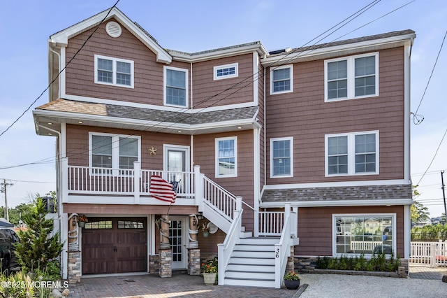 36 Joy Rd, Manahawkin, NJ 08050 - view of front of property featuring a garage, a shingled roof, decorative driveway, stairs, and a porch
