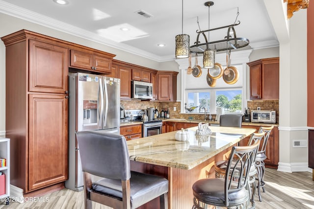 36 Joy Rd, Manahawkin, NJ 08050 - kitchen featuring stainless steel appliances, a kitchen bar, light stone counters, a center island, and tasteful backsplash