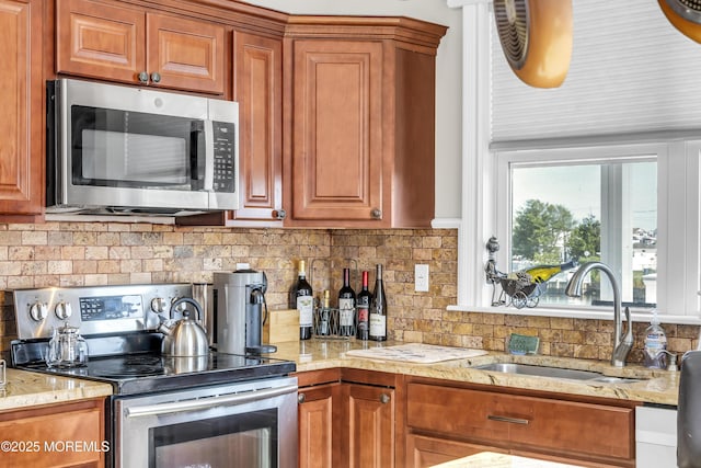 36 Joy Rd, Manahawkin, NJ 08050 - kitchen featuring stainless steel appliances, tasteful backsplash, and brown cabinets