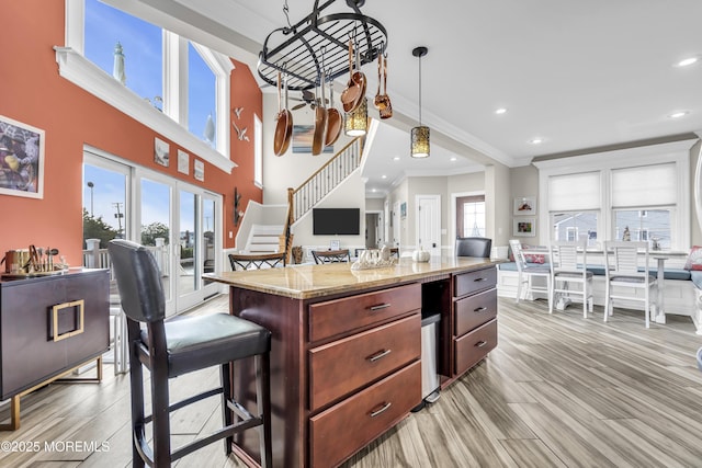 36 Joy Rd, Manahawkin, NJ 08050 - kitchen with ornamental molding, recessed lighting, light wood-type flooring, a center island, and light stone countertops