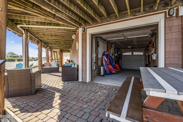 36 Joy Rd, Manahawkin, NJ 08050 - view of patio featuring outdoor lounge area, a water view, and a garage