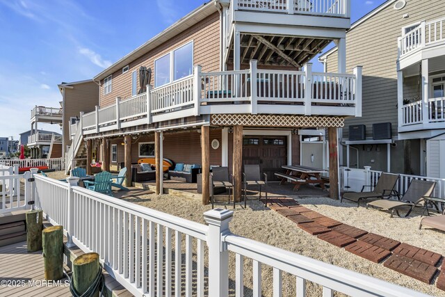 36 Joy Rd, Manahawkin, NJ 08050 - back of property featuring outdoor lounge area, a patio area, and a wooden deck