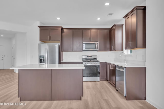750 Lighthouse Dr Unit 1103, Barnegat, NJ 08005 - kitchen featuring stainless steel appliances, light wood finished floors, a kitchen island, dark brown cabinetry, and light countertops