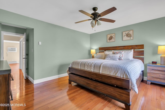 720 Ocean Ave Unit 8, Long Branch, NJ 07740 - bedroom featuring wood finished floors, a baseboard heating unit, a wall mounted AC, and a ceiling fan