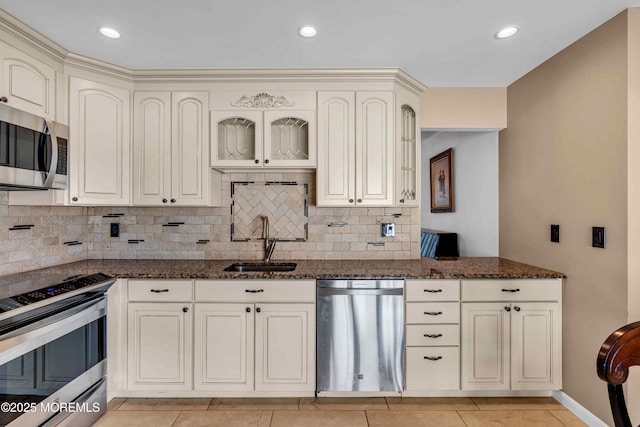 22 Tara Lin Dr, Hazlet, NJ 07730 - kitchen with stainless steel appliances, cream cabinetry, decorative backsplash, dark stone countertops, and recessed lighting