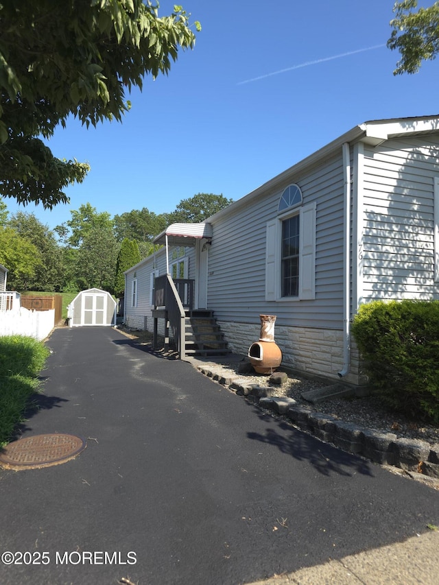 76 Secretariat St Unit 68, Howell, NJ 07731 - view of front facade featuring a storage unit and driveway