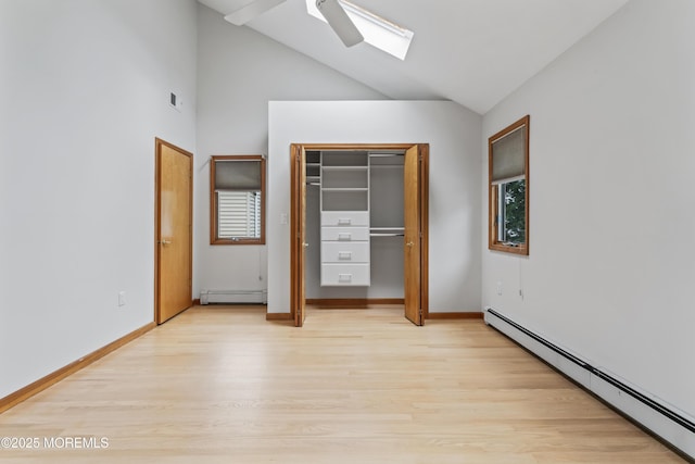24 Bray Ave, North Middletown, NJ 07748 - unfurnished bedroom with baseboard heating, a skylight, a baseboard radiator, light wood-type flooring, and a ceiling fan