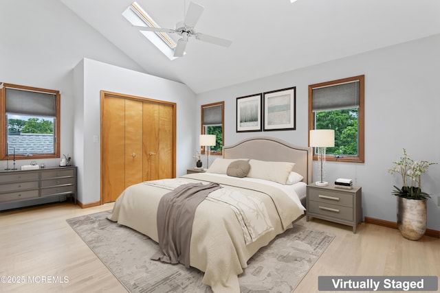 24 Bray Ave, North Middletown, NJ 07748 - bedroom with light wood finished floors, a skylight, a closet, high vaulted ceiling, and a ceiling fan