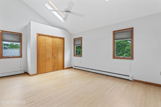 24 Bray Ave, North Middletown, NJ 07748 - unfurnished bedroom with a baseboard radiator, baseboard heating, light wood-style flooring, a closet, and a skylight