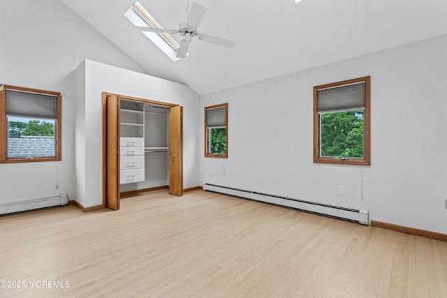 24 Bray Ave, North Middletown, NJ 07748 - unfurnished bedroom featuring baseboard heating, multiple windows, light wood-type flooring, and high vaulted ceiling