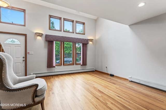 24 Bray Ave, North Middletown, NJ 07748 - foyer entrance with a baseboard heating unit, wood finished floors, a high ceiling, and recessed lighting
