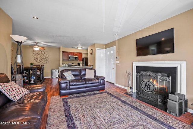 147 Longfield Ct # 147, East Brunswick, NJ 08816 - living area with dark wood-style floors, a ceiling fan, and a lit fireplace