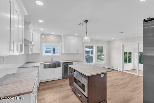 324 Barbados Dr N, Toms River, NJ 08757 - kitchen featuring appliances with stainless steel finishes, baseboard heating, light wood finished floors, white cabinetry, and recessed lighting