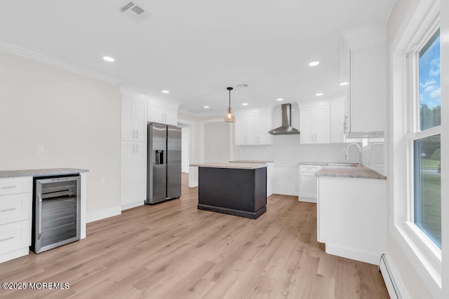 324 Barbados Dr N, Toms River, NJ 08757 - kitchen with stainless steel fridge, beverage cooler, a baseboard radiator, wall chimney exhaust hood, and healthy amount of natural light