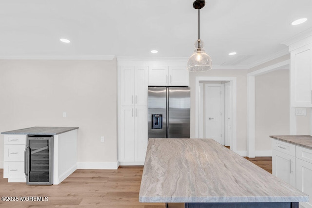 324 Barbados Dr N, Toms River, NJ 08757 - kitchen with wine cooler, stainless steel fridge with ice dispenser, light wood-style floors, white cabinets, and light stone counters