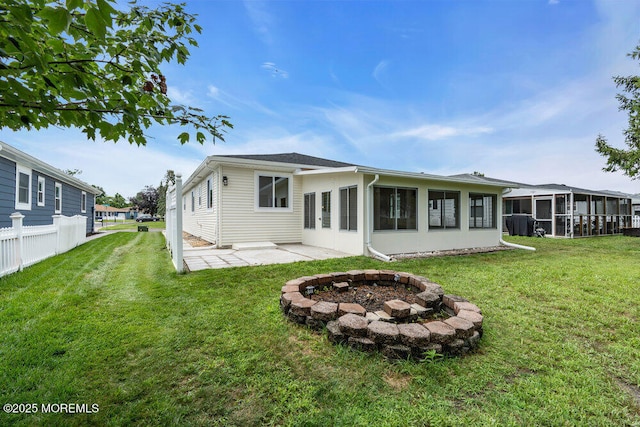 324 Barbados Dr N, Toms River, NJ 08757 - back of house with a sunroom, an outdoor fire pit, a yard, and a patio