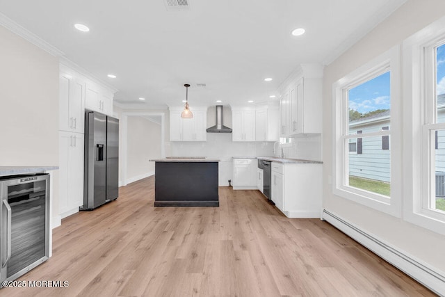 324 Barbados Dr N, Toms River, NJ 08757 - kitchen featuring stainless steel appliances, beverage cooler, a baseboard radiator, wall chimney exhaust hood, and light wood finished floors