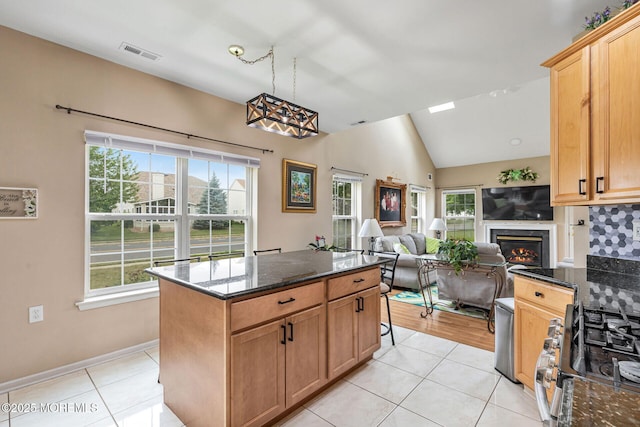 2 Moet Ct, Manchester, NJ 08759 - kitchen featuring vaulted ceiling, light tile patterned floors, open floor plan, and dark stone counters