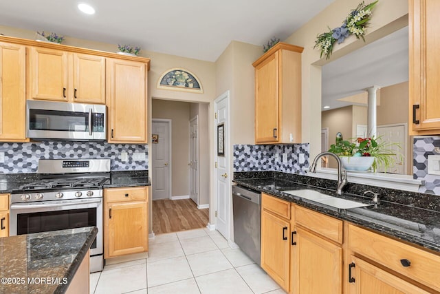 2 Moet Ct, Manchester, NJ 08759 - kitchen with appliances with stainless steel finishes, light brown cabinets, backsplash, dark stone countertops, and light tile patterned floors