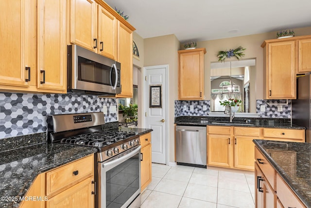 2 Moet Ct, Manchester, NJ 08759 - kitchen featuring appliances with stainless steel finishes, decorative backsplash, light tile patterned flooring, and dark stone counters