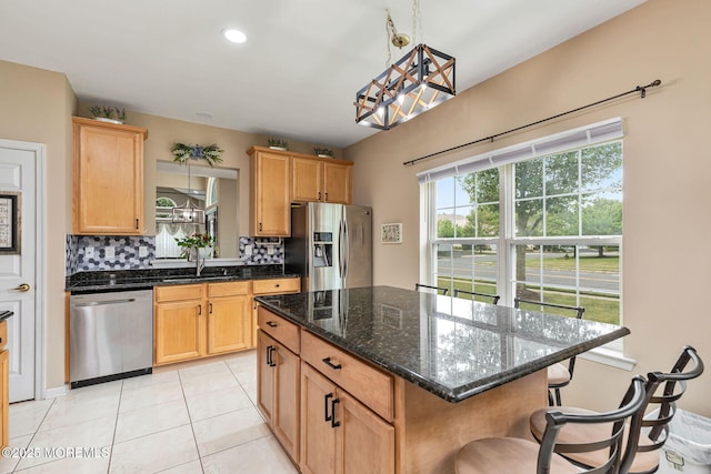 2 Moet Ct, Manchester, NJ 08759 - kitchen featuring stainless steel appliances, a kitchen bar, tasteful backsplash, light tile patterned floors, and dark stone counters