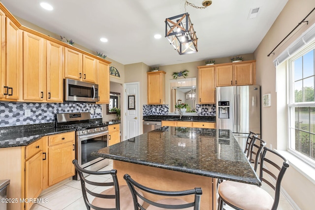 2 Moet Ct, Manchester, NJ 08759 - kitchen with appliances with stainless steel finishes, backsplash, healthy amount of natural light, a breakfast bar area, and recessed lighting