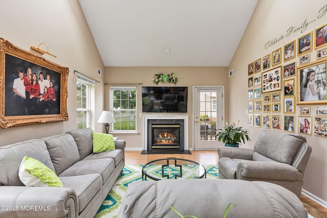 2 Moet Ct, Manchester, NJ 08759 - living room featuring wood finished floors, a fireplace with flush hearth, and high vaulted ceiling