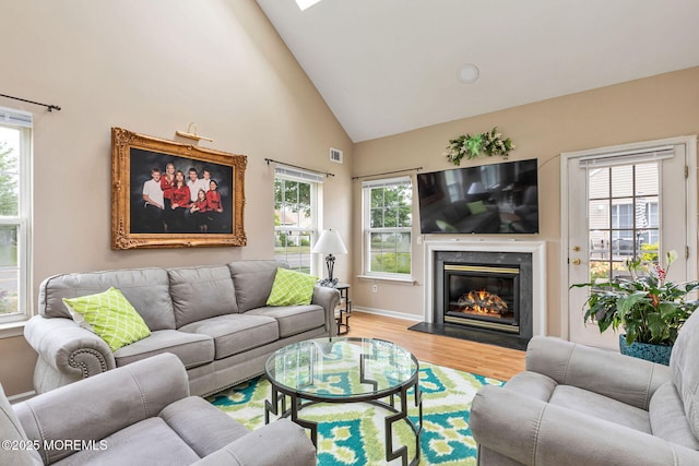 2 Moet Ct, Manchester, NJ 08759 - living area featuring high vaulted ceiling, plenty of natural light, wood finished floors, and a high end fireplace