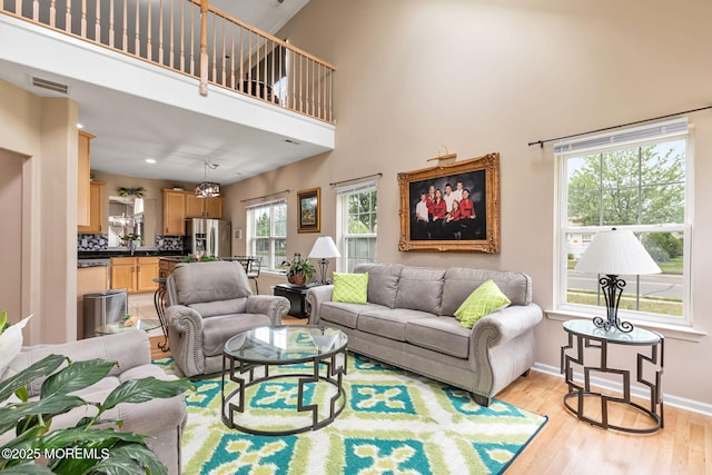 2 Moet Ct, Manchester, NJ 08759 - living area featuring light wood-type flooring, a high ceiling, and recessed lighting