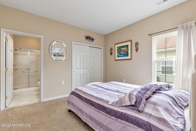 2 Moet Ct, Manchester, NJ 08759 - bedroom featuring light carpet, connected bathroom, a closet, and light tile patterned flooring