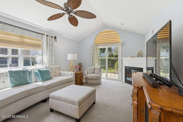 2525 Spring Hill Dr, Toms River, NJ 08755 - living area featuring vaulted ceiling, carpet, healthy amount of natural light, a ceiling fan, and a glass covered fireplace