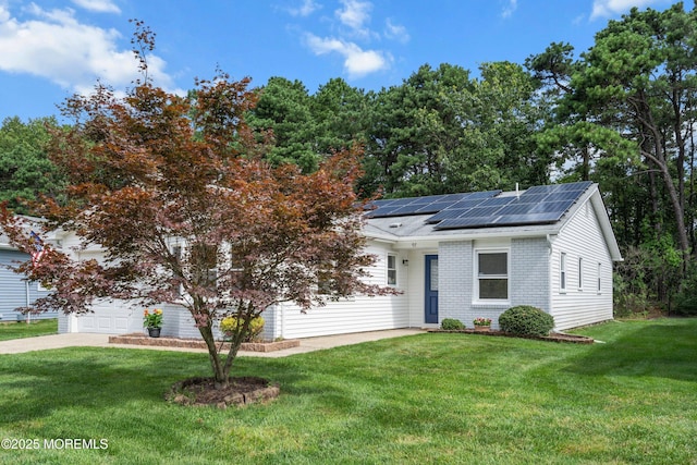 98 Yorkwood Dr, Brick, NJ 08723 - view of front facade featuring roof mounted solar panels, a front yard, a garage, and driveway