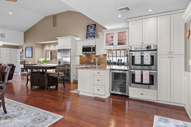 98 Yorkwood Dr, Brick, NJ 08723 - kitchen featuring beverage cooler, stainless steel appliances, decorative backsplash, white cabinetry, and dark wood-type flooring