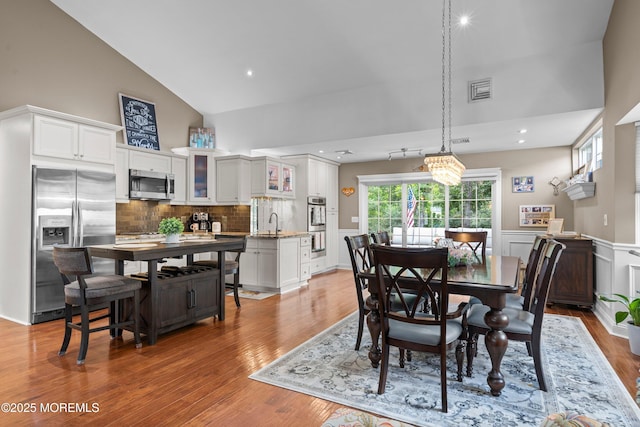 98 Yorkwood Dr, Brick, NJ 08723 - dining space featuring high vaulted ceiling, light wood-style flooring, recessed lighting, and a wainscoted wall