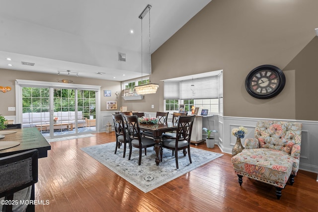98 Yorkwood Dr, Brick, NJ 08723 - dining room featuring a wainscoted wall, high vaulted ceiling, wood finished floors, and a decorative wall