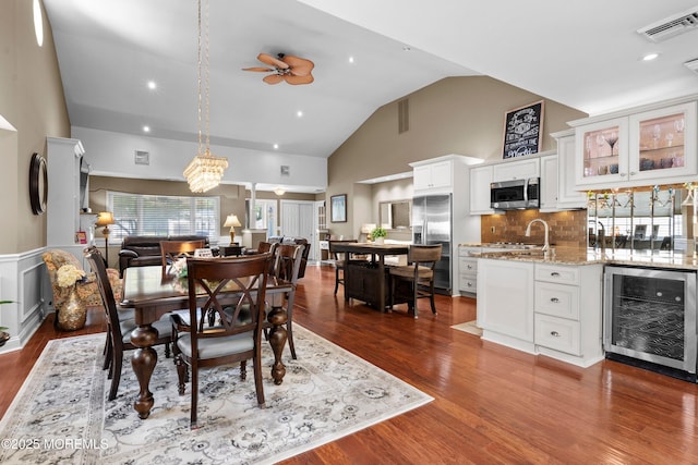 98 Yorkwood Dr, Brick, NJ 08723 - dining space featuring beverage cooler, a ceiling fan, dark wood finished floors, high vaulted ceiling, and recessed lighting