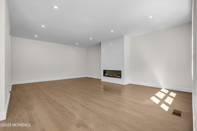 21 Pension Hill Rd, Manalapan, NJ 07726 - unfurnished living room featuring wood finished floors, a large fireplace, and recessed lighting